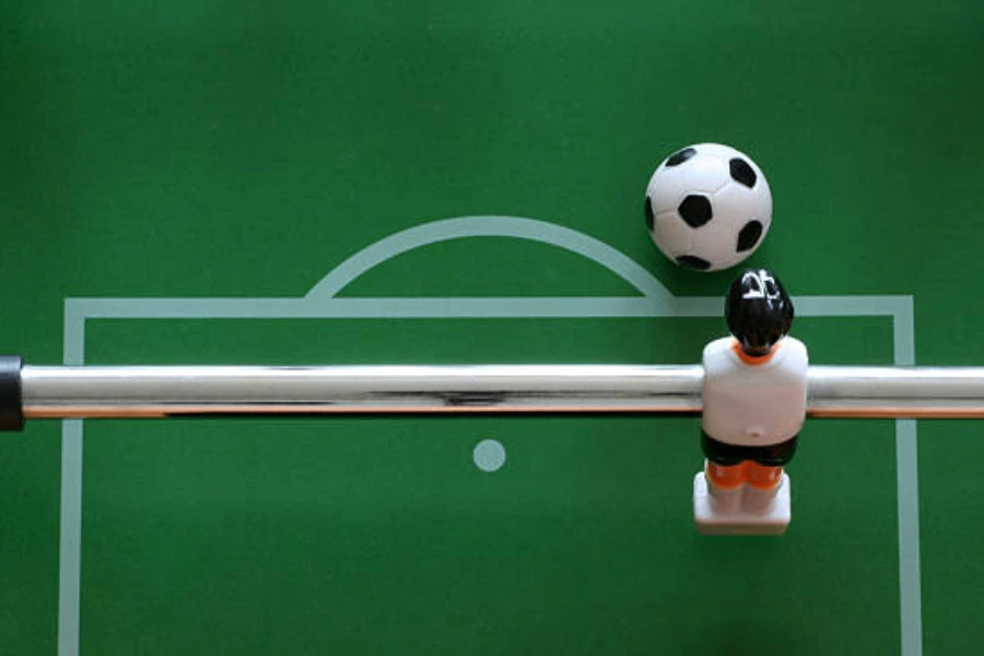 Close-up photo of foosball table goalkeeper and small ball