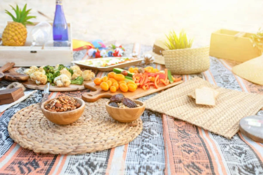 Colorful waterproof beach blanket with food laid on top