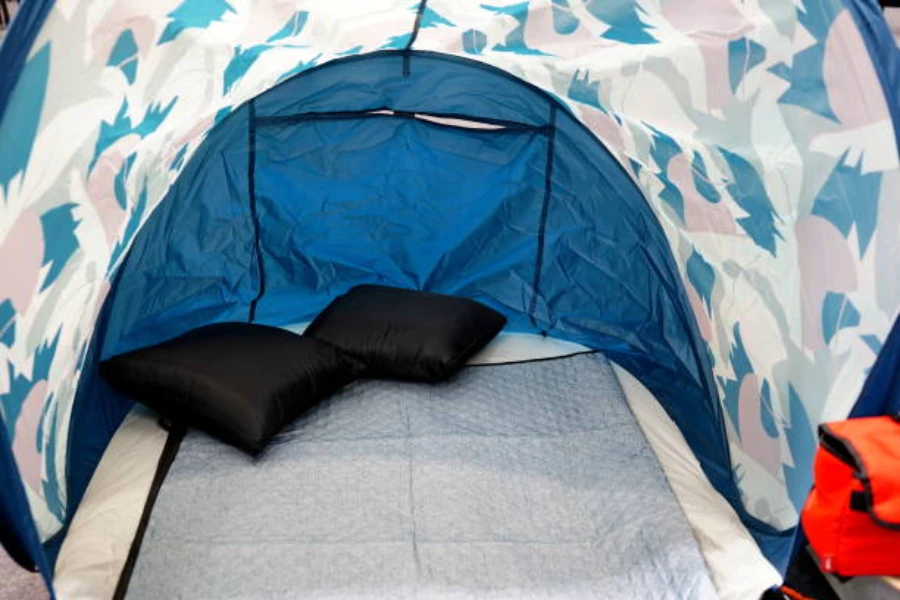 Double foam camping mat inside tent with pillows