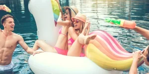 four people playing with swimming rings