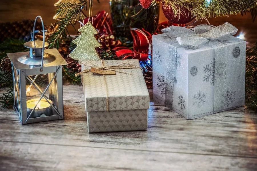 Gift boxes placed near a Christmas tree