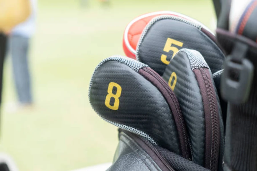 Golf clubs with classic black head covers and zippers