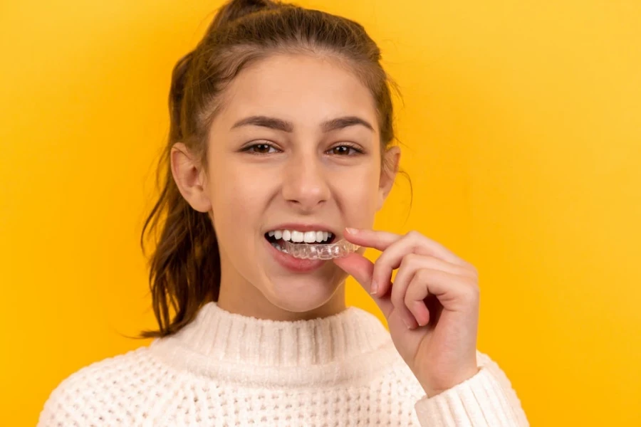 Lady about to use a transparent mouth guard