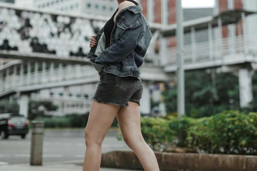 Lady donning a black frayed short and denim jacket