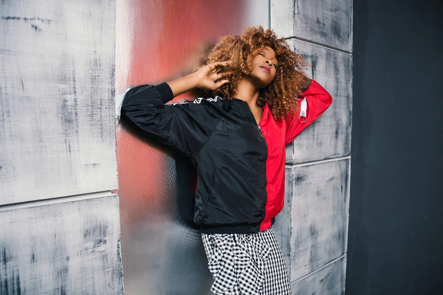 Lady posing in a black and red bomber jacket