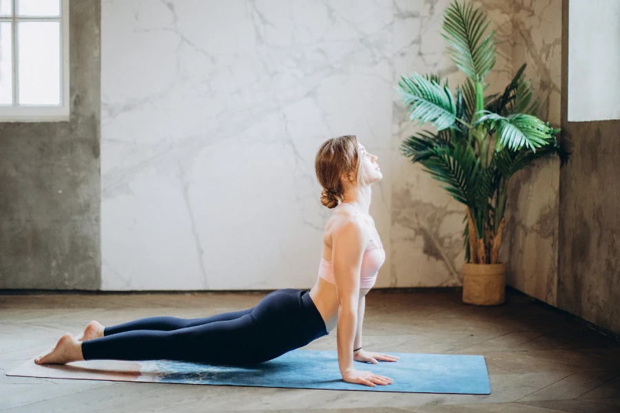 Lady using a smart yoga mat