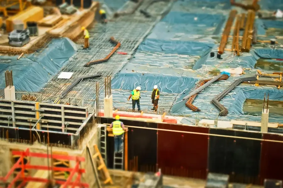 Man in yellow safety vest climbing on a ladder