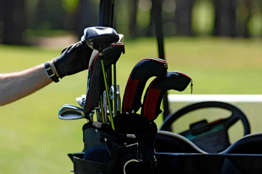 Man pulling golf club out of black golf bag