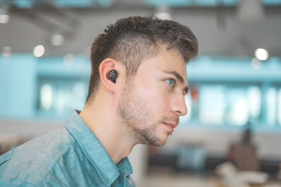 Man using noise-canceling earbuds