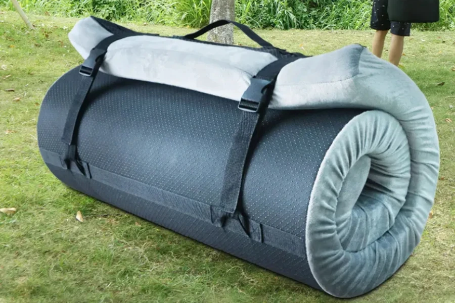 Memory foam camping mat rolled with straps holding it