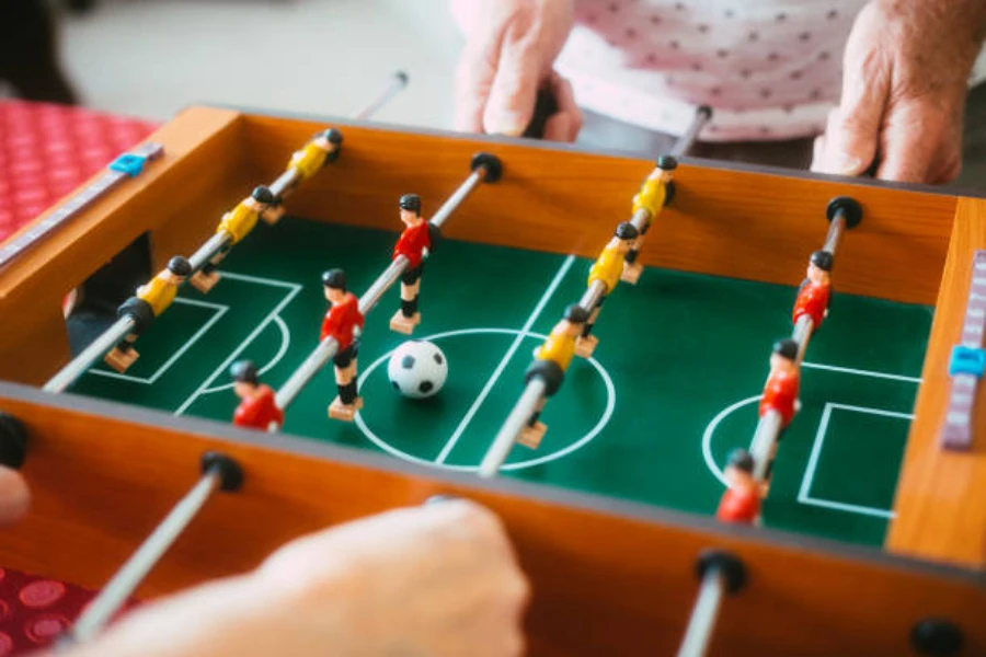 Mini foosball table being used by two individuals