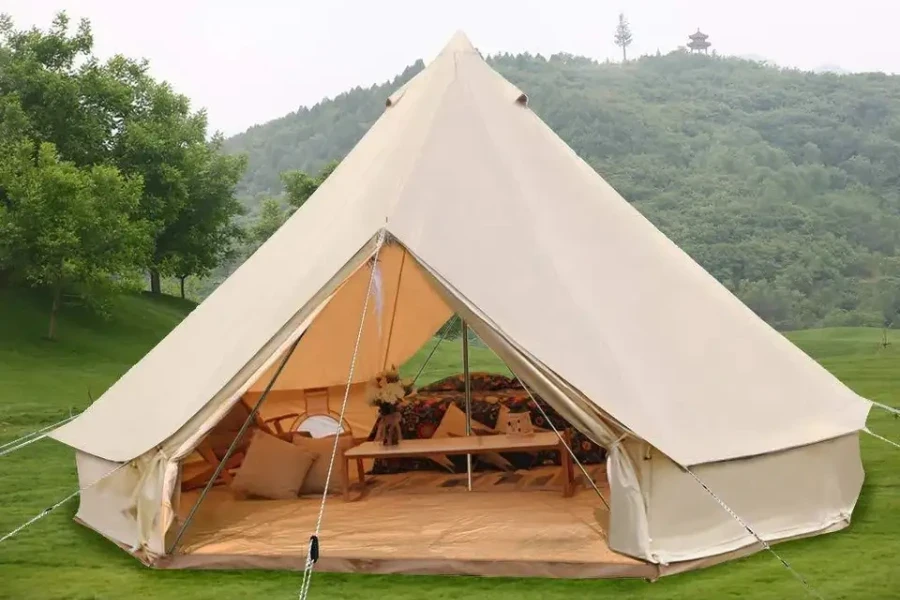 Modern canvas yurt with the flap open in field