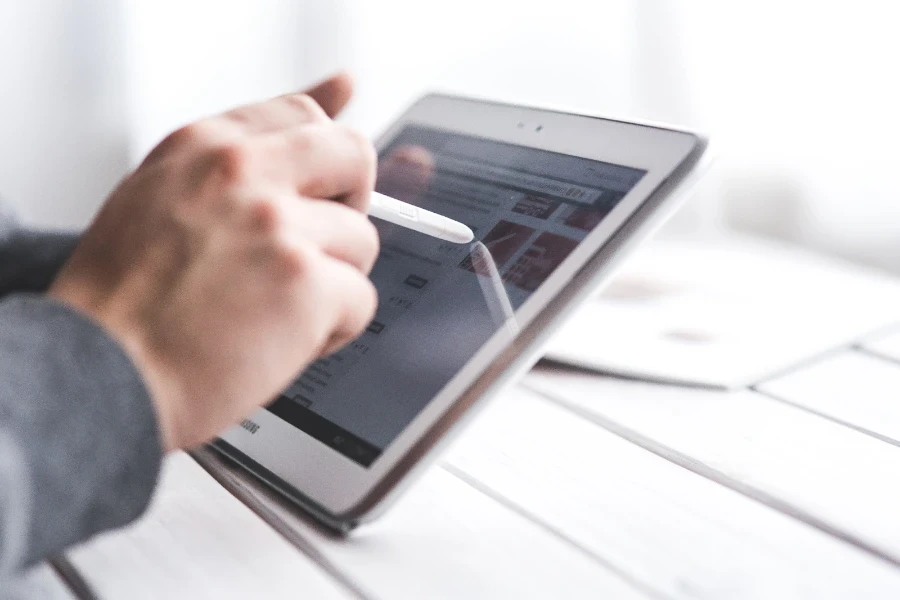 Person operating a tablet with a stylus