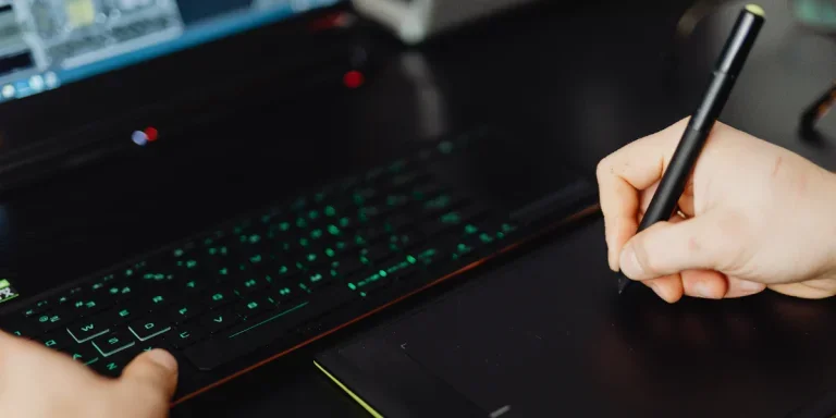 person using a stylus pen on a drawing tablet