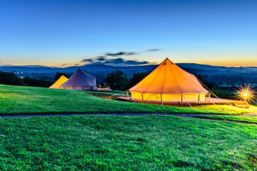 Row of yurt tents in the evening lit up