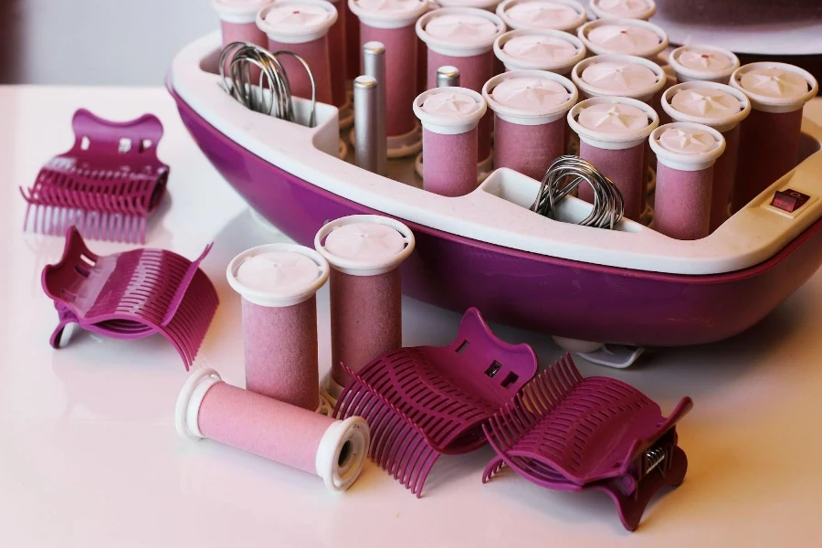 Several hot rollers among other hair accessories