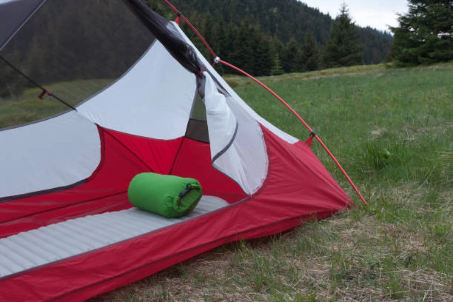 Small tent with ultra light sleeping pad laid out inside