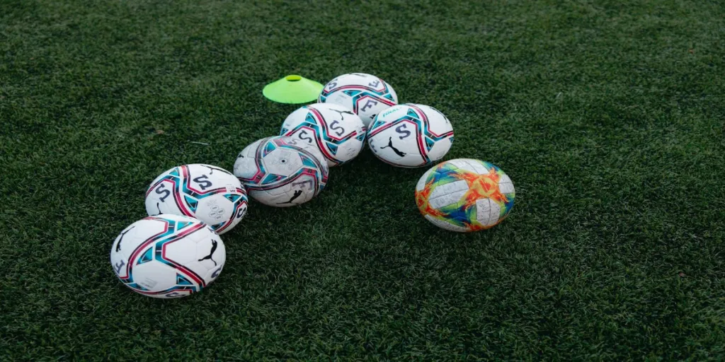 Soccer balls on a football pitch