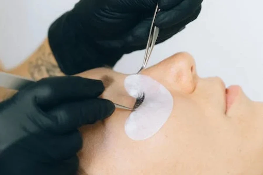 Stylist applying lashes on a woman