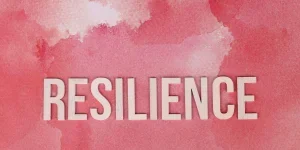 the word resilience on a pink surface