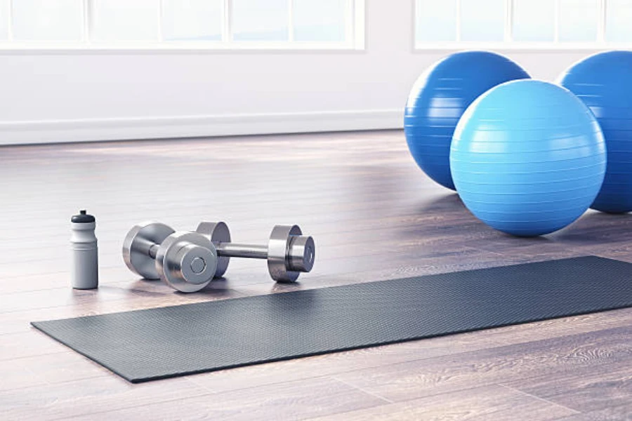 Three large exercise balls next to black gym mat
