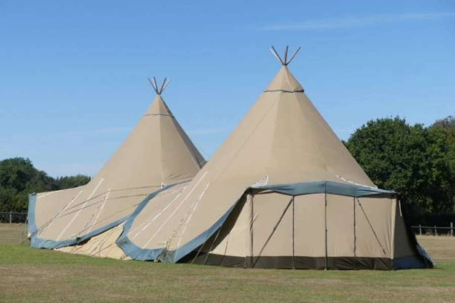 Two modern yurts in triangular design in open field