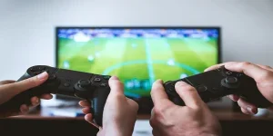Two people holding game controllers