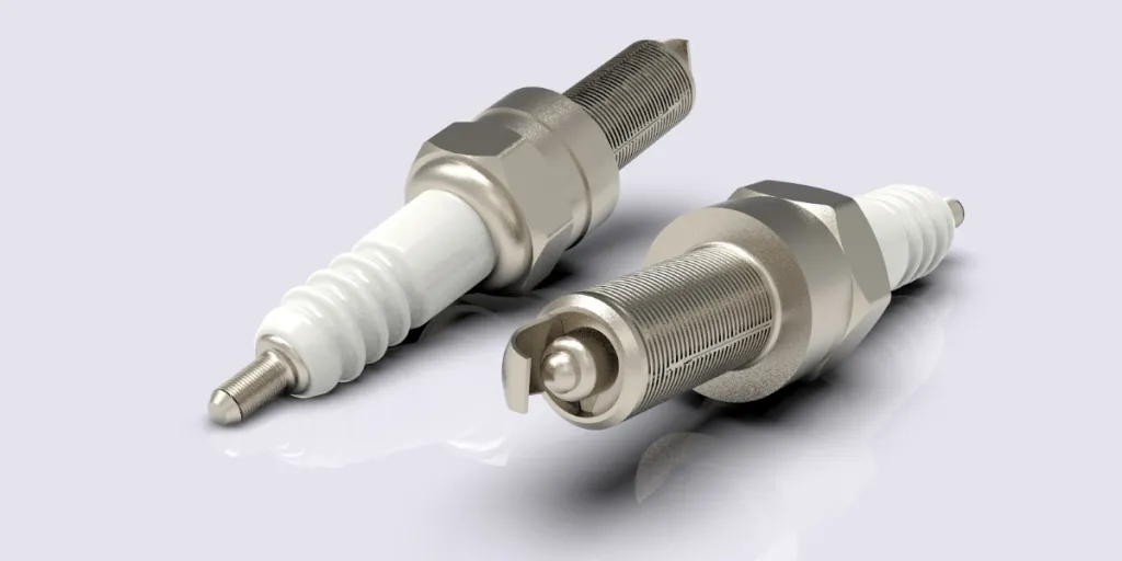 Two spark plugs on a white background
