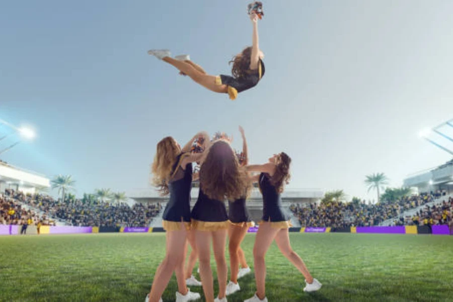 Woman being thrown in the air by squad at game