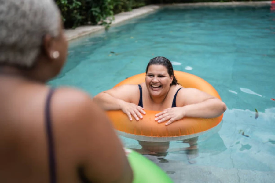 Woman floating in pool with orange swimming ring