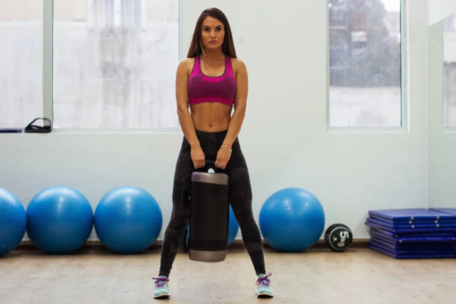 Woman holding small power bag ready for squatting