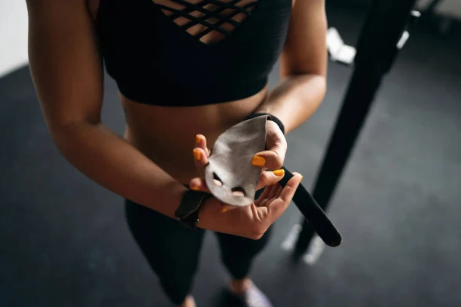 Woman putting on grip pads with two finger openings