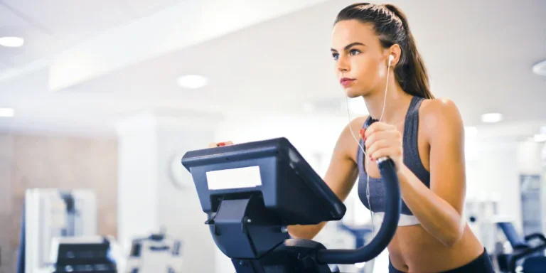 Woman using a smart fitness equipment in a gym