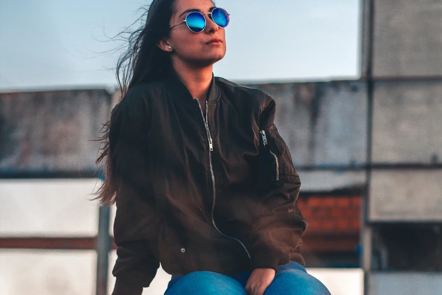 Woman wearing a black bomber jacket