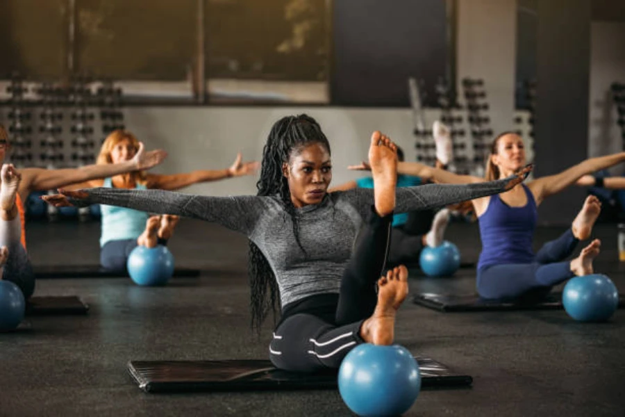 Women using small exercise balls in a pilates class