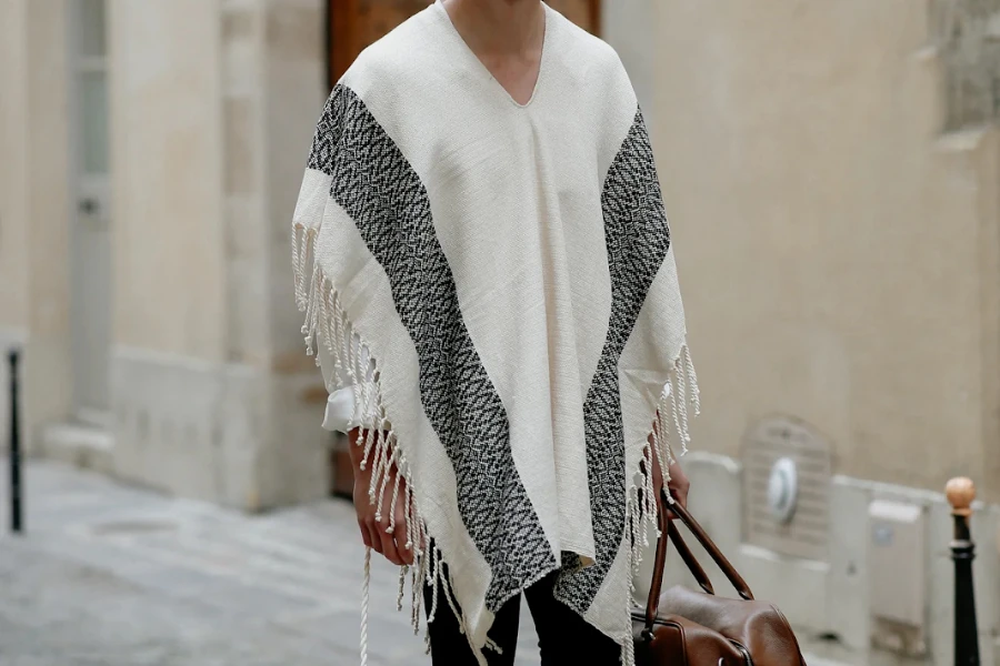 young man in nude snake print poncho