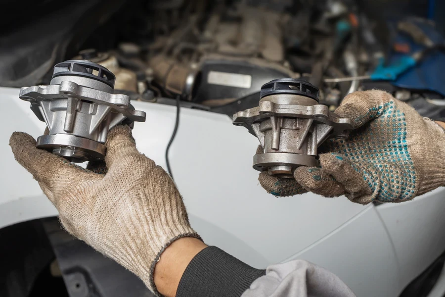 A mechanic fixing a water pump issue
