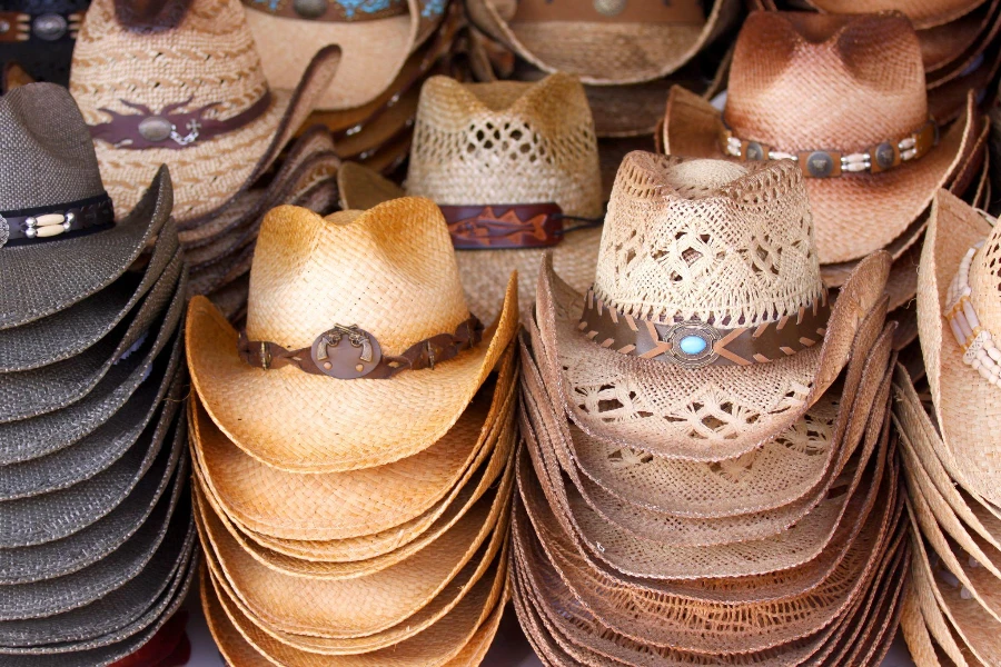 Several stacks of straw cowboy hats arranged in rows