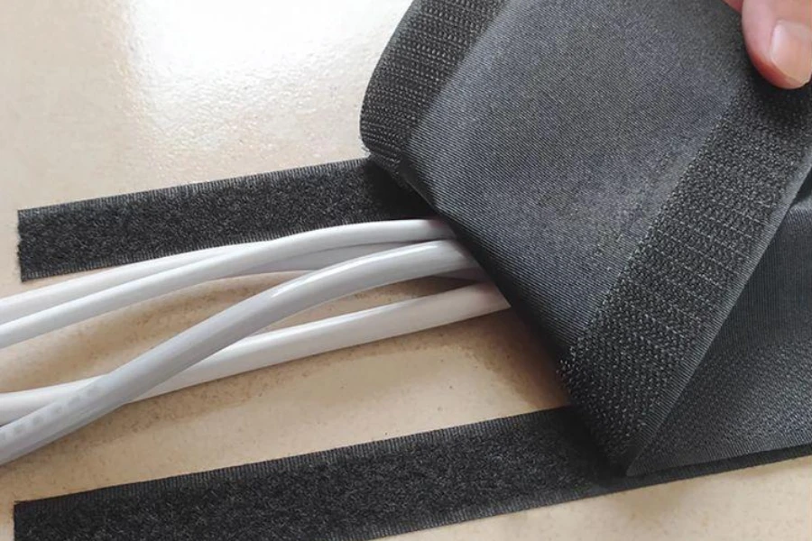 A black cable sleeve covering white cables