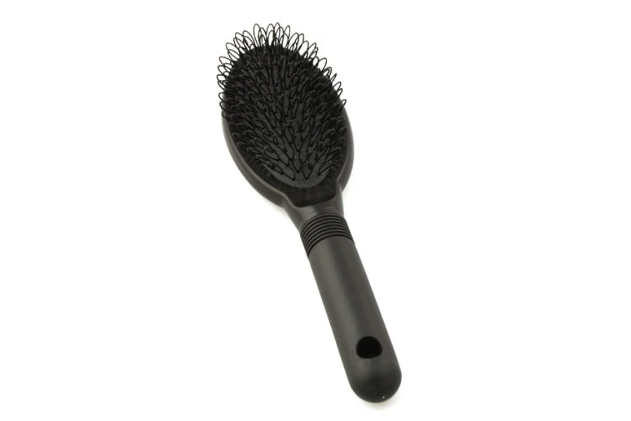 a black wig brush on a white background