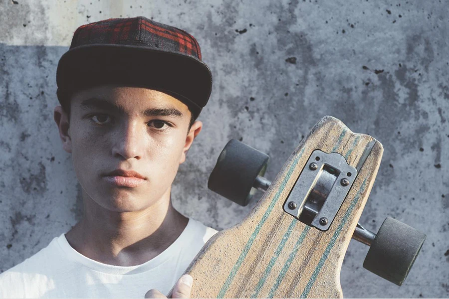 a boy holding a skateboard