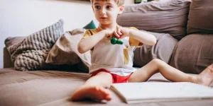 a cute boy playing with a drawing pad