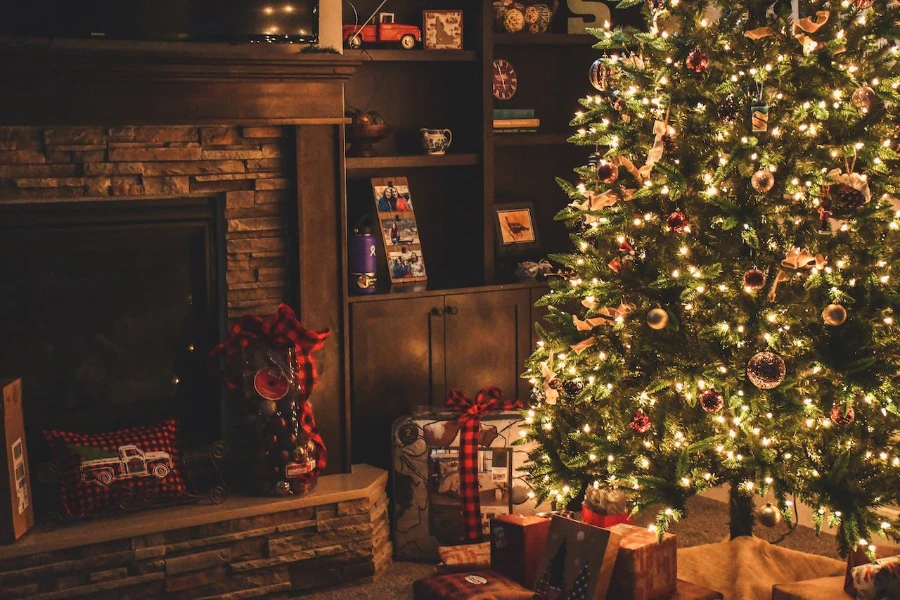 A decorated Christmas tree near a fireplace