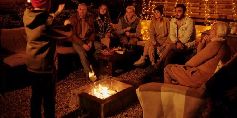 A family gathered by a fire pit