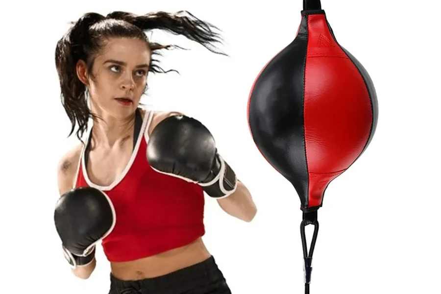 A female MMA practitioner practicing with a speed bag