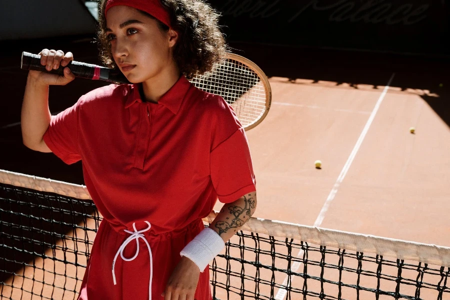 a female tennis player wearing a white sports wristband