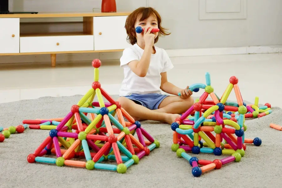 A kid playing with magnetic building blocks