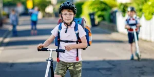 a kid riding a scooter