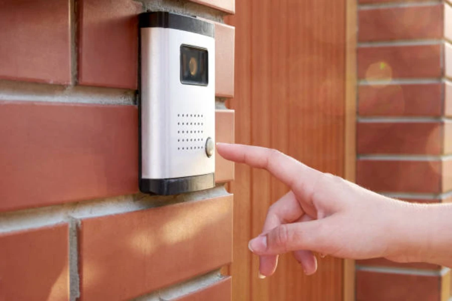A lady close to ringing a smart doorbell equipped