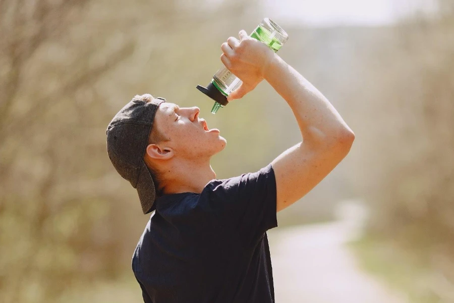 a man drinking from a sports bottle